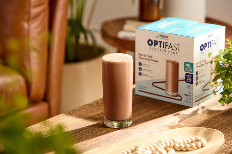 OPTIFAST 900 next to other meal replacement shakes in a Canadian kitchen setting.